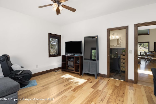 living area featuring ceiling fan and wood-type flooring