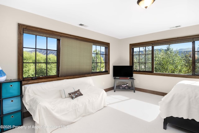 bedroom featuring light carpet