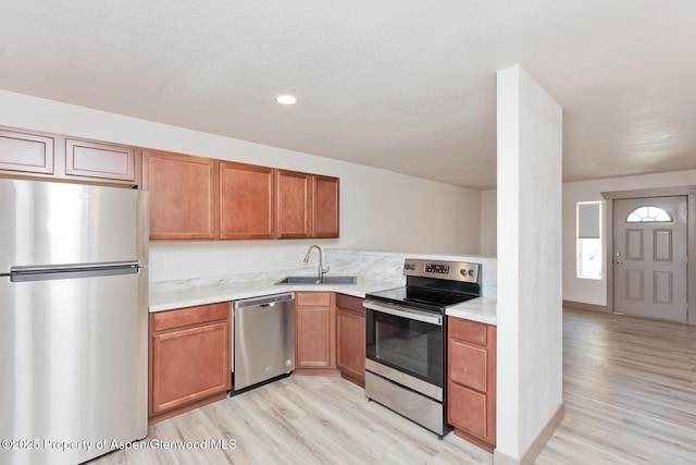 109 Anna Ct Unit B8, Grand Junction, CO 81503 - kitchen with stainless steel appliances, light wood finished floors, light countertops, brown cabinetry, and recessed lighting
