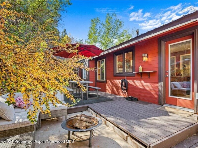 wooden deck featuring an outdoor fire pit