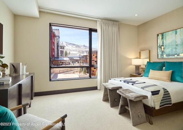 carpeted bedroom featuring multiple windows and a mountain view