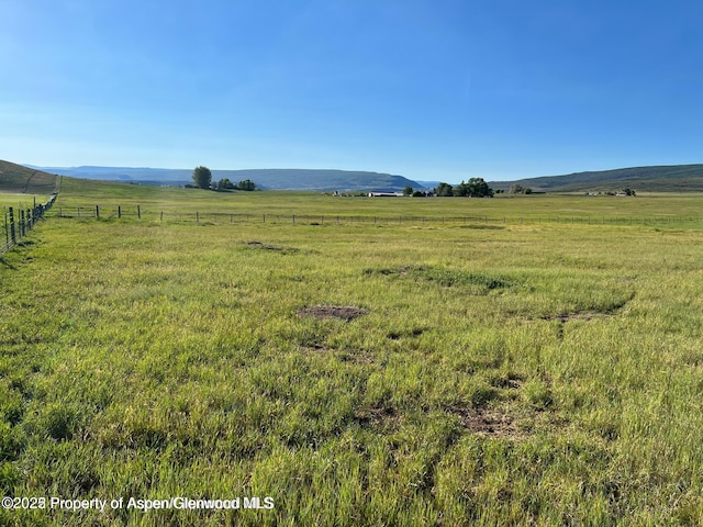 mountain view featuring a rural view