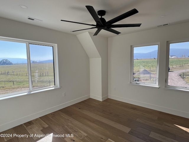 additional living space featuring ceiling fan, a rural view, a mountain view, and dark hardwood / wood-style floors