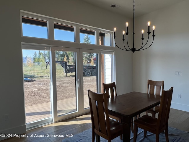 dining area featuring hardwood / wood-style floors and a chandelier