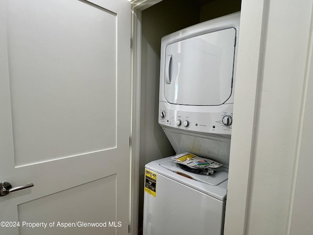 laundry area featuring stacked washing maching and dryer