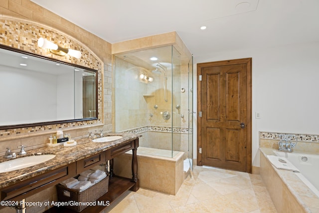 bathroom with plus walk in shower, vanity, tile patterned flooring, and tile walls