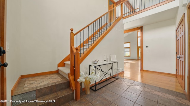 148 Laird Ln, Glenwood Springs, CO 81601 - staircase featuring a towering ceiling and baseboards