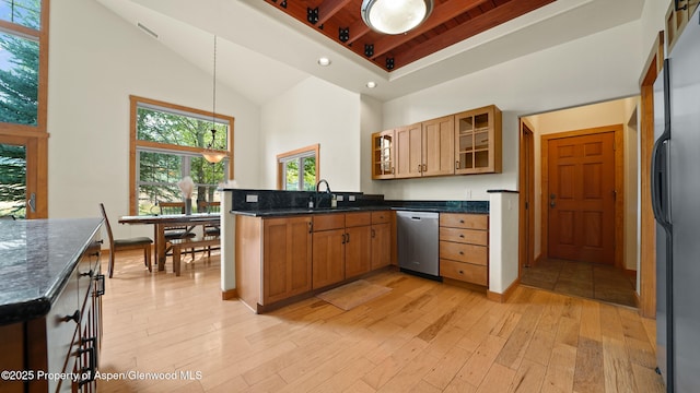 148 Laird Ln, Glenwood Springs, CO 81601 - kitchen with stainless steel dishwasher, a high ceiling, light wood-style flooring, freestanding refrigerator, and a peninsula