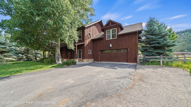 148 Laird Ln, Glenwood Springs, CO 81601 - chalet / cabin with a garage, driveway, and roof with shingles