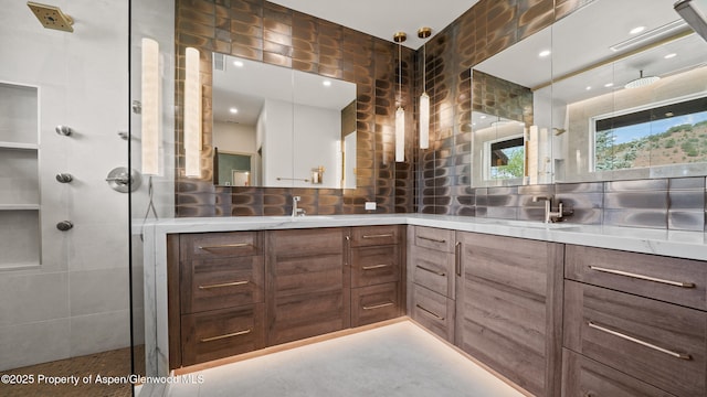 148 Laird Ln, Glenwood Springs, CO 81601 - full bathroom with double vanity, a stall shower, and decorative backsplash
