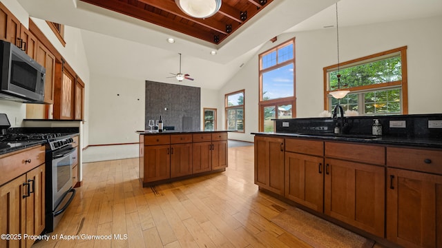 148 Laird Ln, Glenwood Springs, CO 81601 - kitchen featuring appliances with stainless steel finishes, brown cabinetry, high vaulted ceiling, light wood-type flooring, and ceiling fan