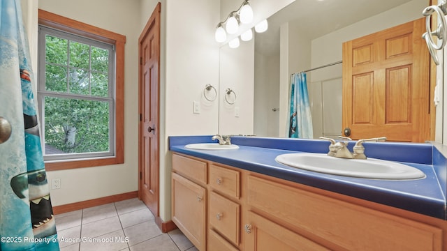 148 Laird Ln, Glenwood Springs, CO 81601 - full bathroom featuring plenty of natural light, double vanity, tile patterned flooring, and curtained shower