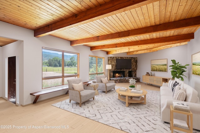 176 Letey Ln, Woody Creek, CO 81656 - living room featuring light wood-style flooring, a stone fireplace, and a wooden ceiling with exposed beams