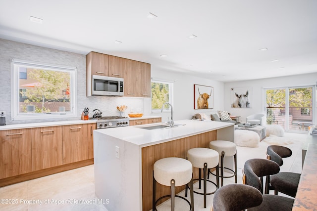 210 E Cooper Ave Unit 3G, Aspen, CO 81611 - kitchen with a sink, stainless steel microwave, modern cabinets, and a breakfast bar