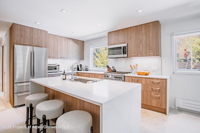 210 E Cooper Ave Unit 3G, Aspen, CO 81611 - kitchen with appliances with stainless steel finishes, modern cabinets, a sink, and tasteful backsplash