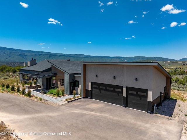 modern home with a mountain view and a garage