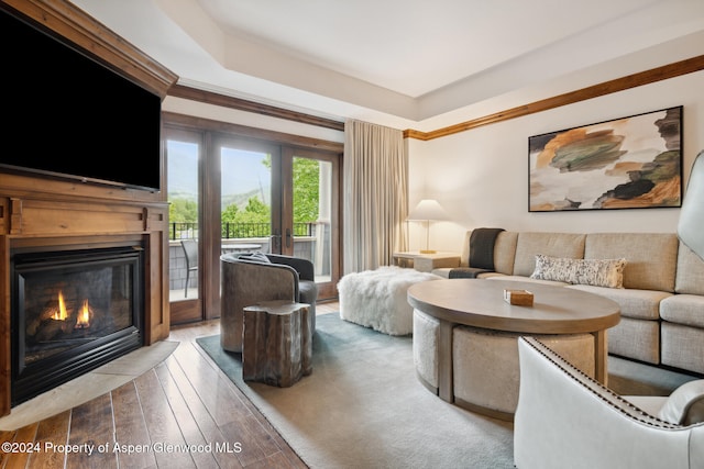 living room with hardwood / wood-style flooring and ornamental molding