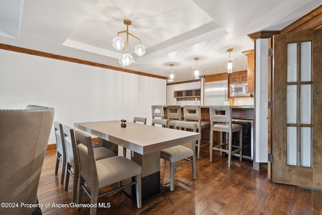 dining area featuring a tray ceiling, wine cooler, and dark hardwood / wood-style floors