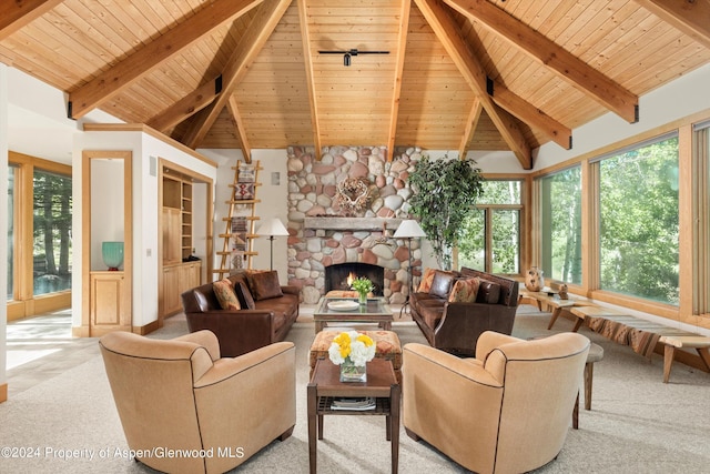 living room featuring beam ceiling, a fireplace, light colored carpet, and wooden ceiling