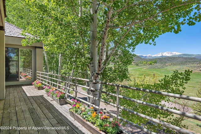 deck featuring a mountain view and a rural view