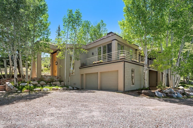 view of front of property with a balcony and a garage