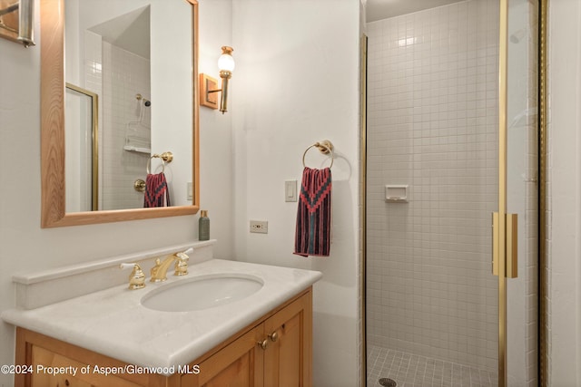 bathroom with vanity and a shower with door