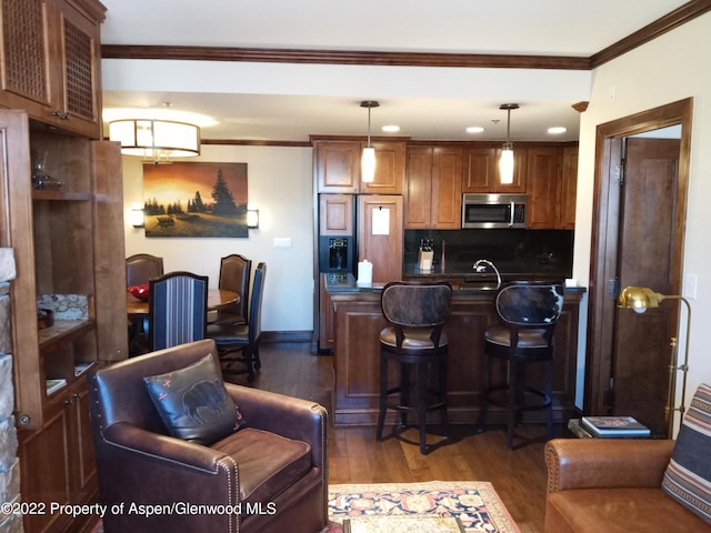 living room with crown molding, sink, and dark wood-type flooring