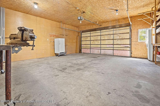 648 Colorado St, Craig, CO 81625 - garage featuring a garage door opener and freestanding refrigerator