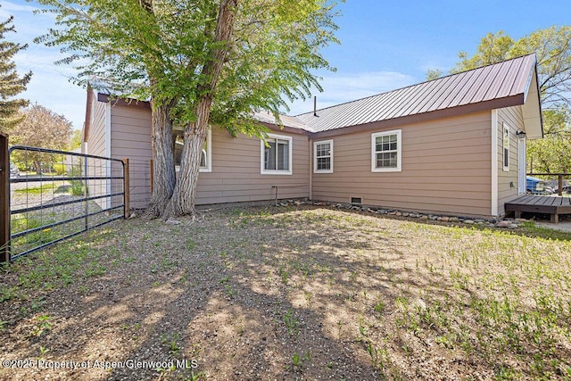 648 Colorado St, Craig, CO 81625 - back of house featuring a gate, metal roof, and a wooden deck