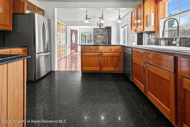 648 Colorado St, Craig, CO 81625 - kitchen featuring granite floors, backsplash, brown cabinets, and a peninsula