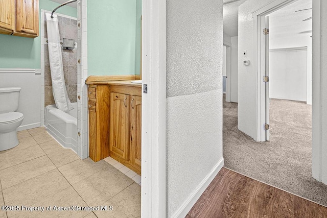 648 Colorado St, Craig, CO 81625 - bathroom with toilet, shower / tub combo, a textured wall, and baseboards