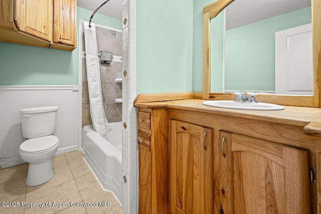 648 Colorado St, Craig, CO 81625 - bathroom with toilet, vanity, tile patterned floors, shower / bath combination with curtain, and a wainscoted wall