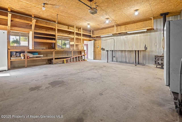 648 Colorado St, Craig, CO 81625 - garage featuring a garage door opener and freestanding refrigerator