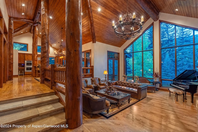 living room featuring beamed ceiling, wood-type flooring, high vaulted ceiling, and a notable chandelier