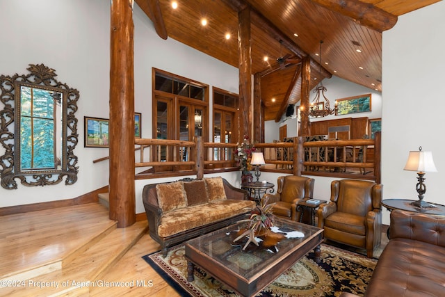 living room with beamed ceiling, hardwood / wood-style floors, high vaulted ceiling, and wooden ceiling