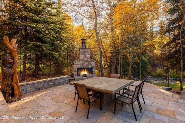 view of patio with an outdoor stone fireplace