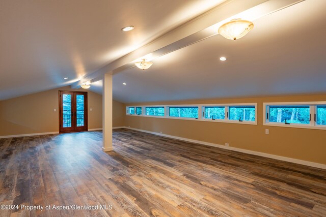 bonus room with french doors, dark wood-type flooring, and vaulted ceiling