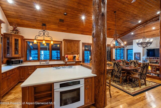 kitchen with wall oven, wood ceiling, a notable chandelier, and white gas stovetop