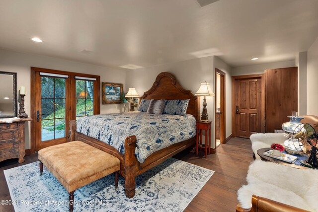 bedroom with dark hardwood / wood-style flooring