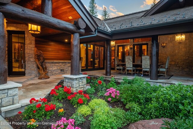 back house at dusk featuring french doors