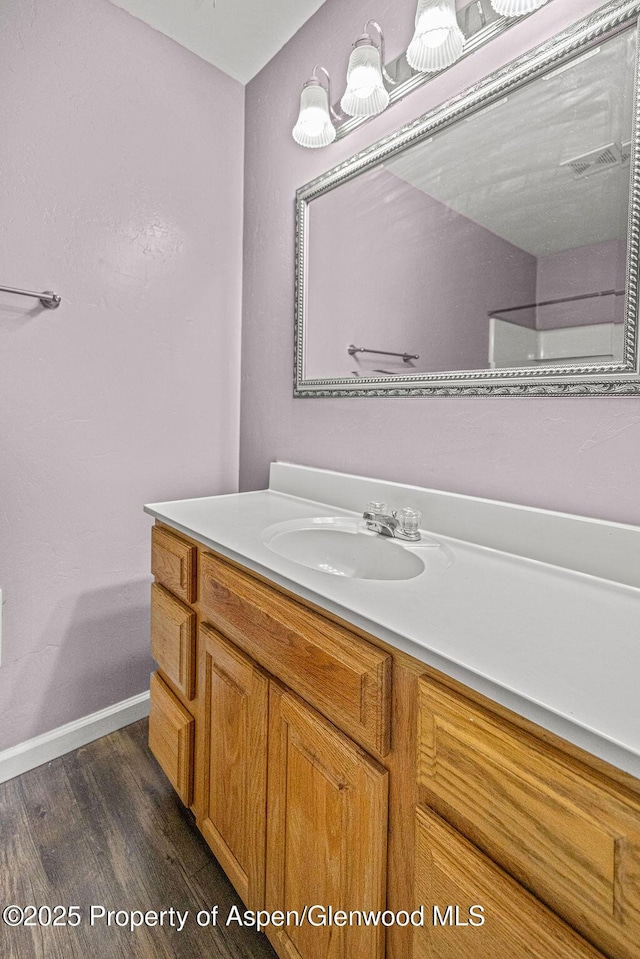 627 Lake St, Rangely, CO 81648 - bathroom with vanity and wood finished floors