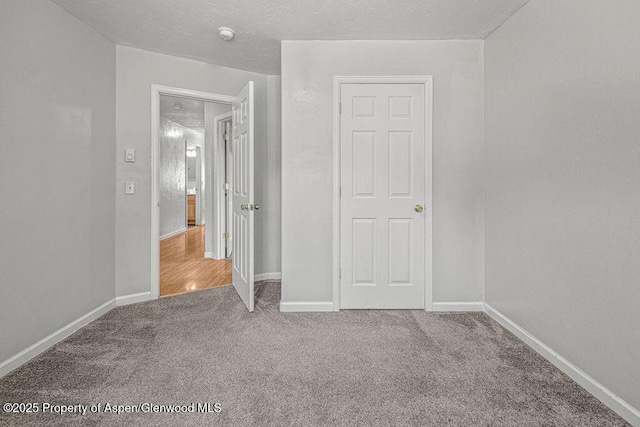 627 Lake St, Rangely, CO 81648 - unfurnished bedroom featuring carpet and baseboards
