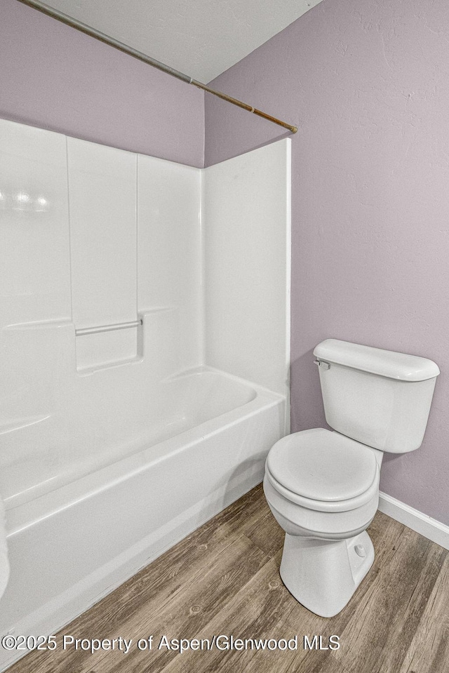 627 Lake St, Rangely, CO 81648 - full bath featuring wood finished floors and bathing tub / shower combination