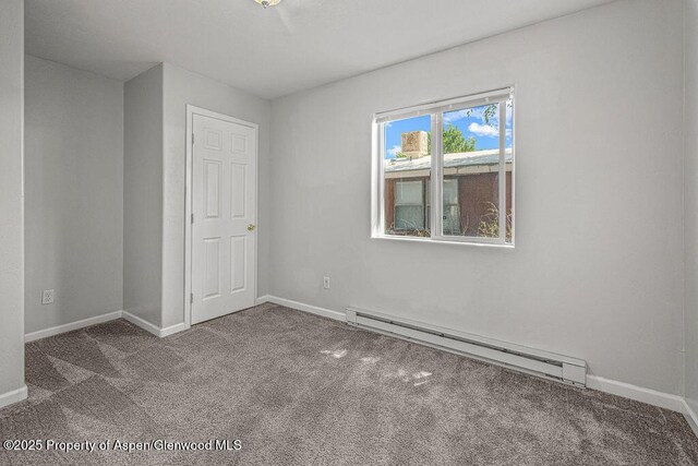 627 Lake St, Rangely, CO 81648 - unfurnished room with a baseboard radiator and carpet floors
