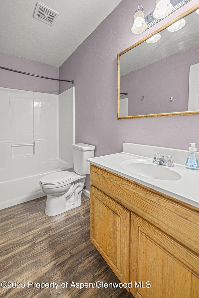 627 Lake St, Rangely, CO 81648 - full bath featuring vanity, wood finished floors, and bathtub / shower combination