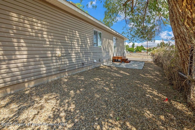 627 Lake St, Rangely, CO 81648 - view of side of property with a patio area