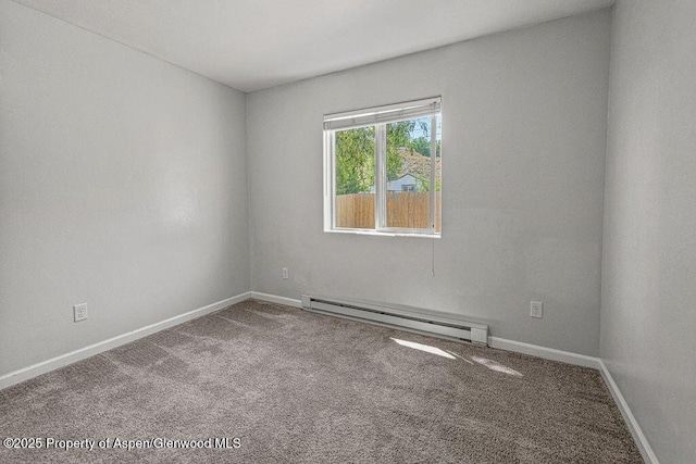 627 Lake St, Rangely, CO 81648 - carpeted empty room featuring baseboard heating and baseboards