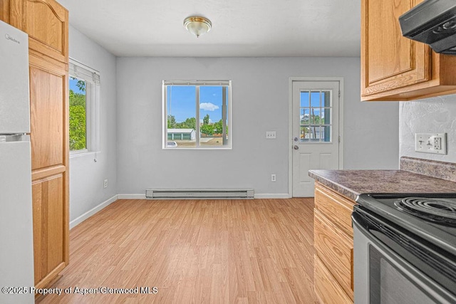 627 Lake St, Rangely, CO 81648 - kitchen featuring light wood-style floors, electric range, freestanding refrigerator, exhaust hood, and baseboard heating