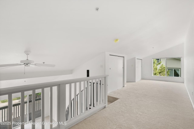 hall featuring lofted ceiling and carpet flooring