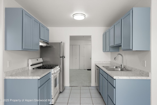 kitchen with white range with gas stovetop, a sink, under cabinet range hood, dishwasher, and light countertops